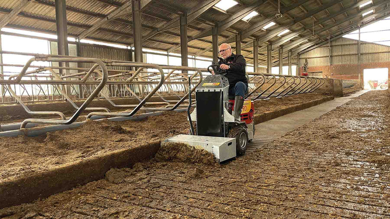 Slurry scraping in a cow barn using a ride on machine