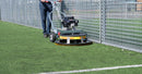 Person using a Westermann WR870 Astro Turf Power Brush on artificial turf