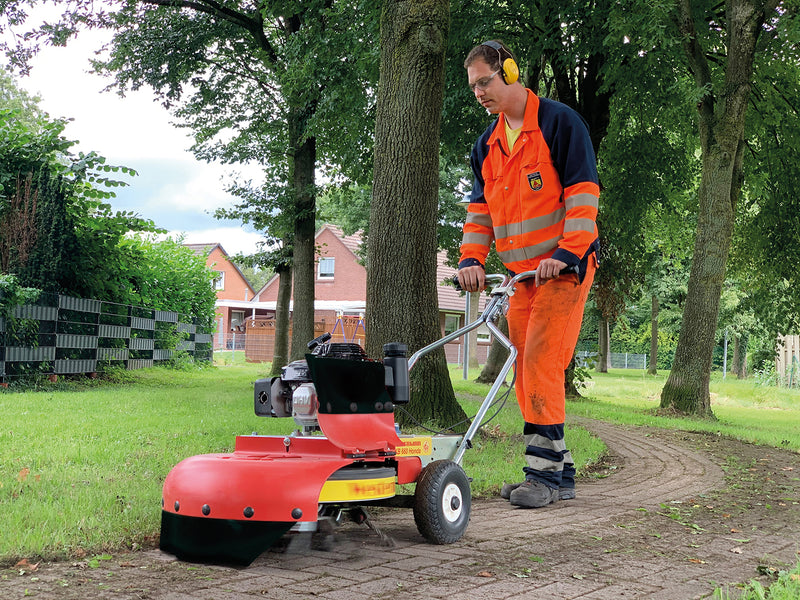 Moss removal with a wheeled machine by a contractor
