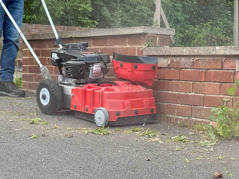 WKB430 clearing weeds from wall bottoms
