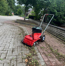 A Westermann WKB430 EGO Weed Ripper on a block paving driveway, showing moss and debris that has been cleared by the machine.