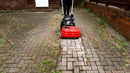 Person using a Westermann WKB430 Weed Ripper to clear weeds from in between block paving on a driveway