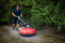 Person using a Westermann WKB660 Weed Ripper to clean block paving