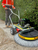 Person using a Westermann Moss Brush on a driveway