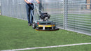 Person using a Westermann WR870 Moss Brush with Astro Turf Power Brush head, to clean Astroturf 