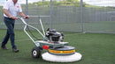 Person using a Westermann WR870 Moss Brush with double poly head, on artificial turf