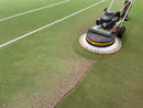 Person using a Westermann WR870 Moss Brush with a double poly brush head to sweep artificial turf