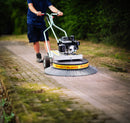 Person using a Westermann WR870 Moss Brush to clear moss on block paving
