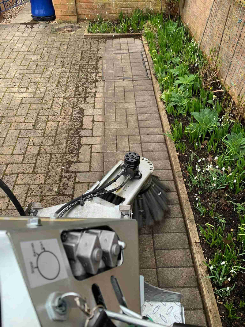 WKB550 brush head clearing moss from block paving