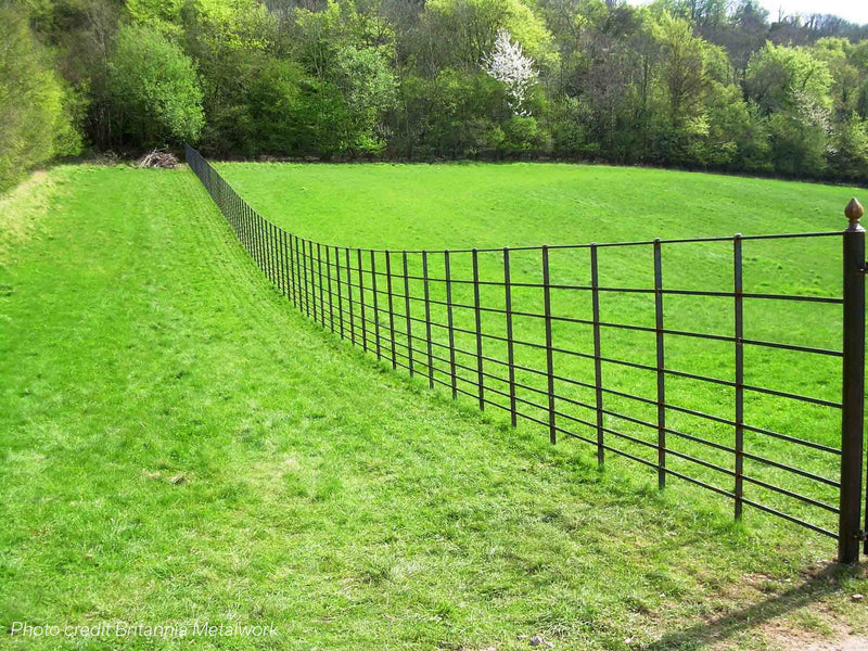 Estate Fencing down the middle of a green field