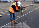 A person using an Easy Petrol Post Driver to drive a Spirafix anchor into the ground