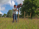 A person driving in 3" round timber posts with the Easy Petrol Post Driver