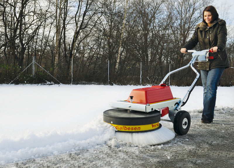 Westermann Battery Sweeper with Deep Drum sweeping snow aside