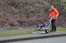Contractor cleaning block footpath with the Westermann Moss Brush