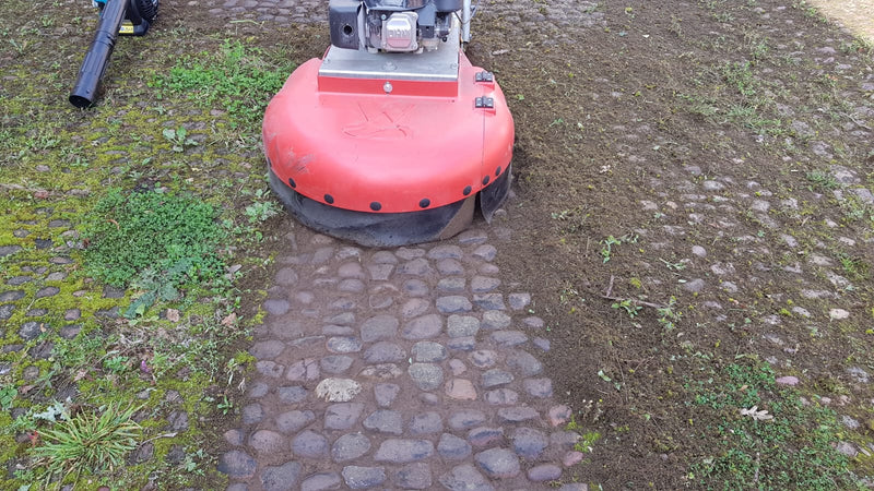 Removing debris, weeds, and moss from cobbled stones